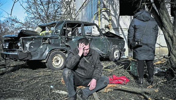 A man sits outside his destroyed building after bombings on the eastern Ukraine town of Chuguiv on February 24, 2022, as Russian armed forces are trying to invade Ukraine from several directions, using rocket systems and helicopters to attack Ukrainian position in the south, the border guard service said. Russia's ground forces on Thursday crossed into Ukraine from several directions, Ukraine's border guard service said, hours after President Vladimir Putin announced the launch of a major offensive. Russian tanks and other heavy equipment crossed the frontier in several northern regions, as well as from the Kremlin-annexed peninsula of Crimea in the south, the agency said. (Photo by Aris Messinis / AFP)
