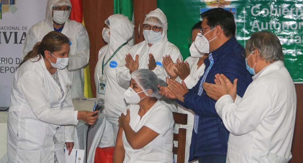 El presidente de Bolivia, Luis Arce (2d), atestigua la primera vacunación contra el COVID-19 del país a la enfermera Sandra Ríos (c), tras la llegada de las primeras 20.000 dosis de la rusa Sputnik V, en el Hospital Japonés de Santa Cruz (Bolivia).  (EFE/ Juan Carlos Torrejon).