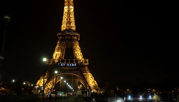 Una imagen muestra las palabras "Quédate en casa" en la Torre Eiffel durante una actividad en Francia destinado a frenar la propagación del COVID-19. (Foto: AFP)