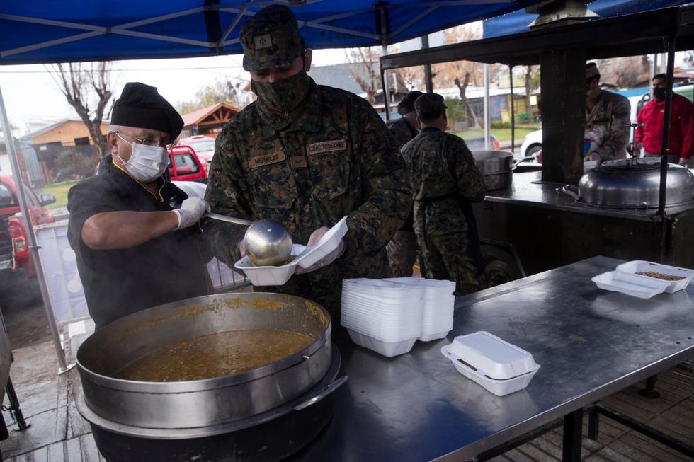 Miembros del Ejército de Chile preparan almuerzos para los vecinos vulnerables de la comuna de Las Condes este martes, en Santiago. (EFE/Alberto Valdés).