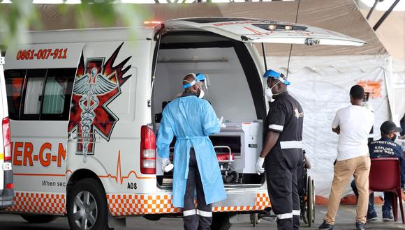 Trabajadores de la salud charlan cerca de una ambulancia en el estacionamiento del Hospital Académico Steve Biko, en medio de un encierro por la enfermedad del coronavirus en todo el país (COVID-19), en Pretoria, Sudáfrica. (REUTERS / Siphiwe Sibeko).