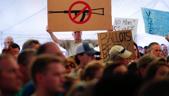 A man displays an anti gun violence sign during a March for our Lives Rally at Fairfield Hills Campus, in Newtown Connecticut on August 12, 2018. (Photo by KENA BETANCUR / AFP)