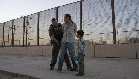 Un menor observa cómo su padre es registrado por el Agente de Aduanas y Protección Fronteriza de los Estados Unidos Frank Pino en El Paso, Texas. (Foto: AFP/Paul Ratje)