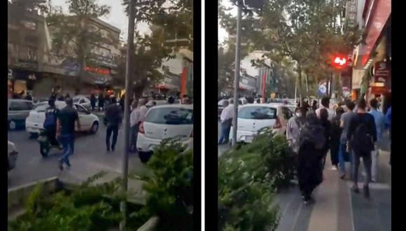 Mujeres aplaudiendo mientras los autos tocan sus bocinas, durante una manifestación en el centro de Teherán. (Foto de CGU/AFP)