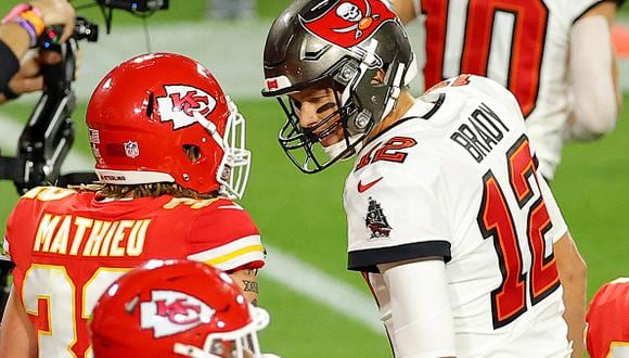TAMPA, FLORIDA - FEBRUARY 07: Tom Brady #12 of the Tampa Bay Buccaneers speaks to Tyrann Mathieu #32 of the Kansas City Chiefs during the second quarter in Super Bowl LV at Raymond James Stadium on February 07, 2021 in Tampa, Florida. (Photo by Kevin C. Cox/Getty Images)