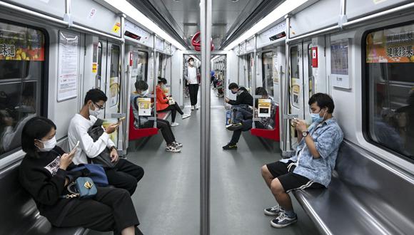 Personas dentro de un tren subterráneo en el distrito de Haizhu, ciudad de Guangzhou, en la provincia de Guangdong, en el sur de China, luego de la relajación de las restricciones por el covid-19 en la ciudad. (Foto por CNS / AFP) / China FUERA