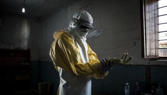 Un trabajador de salud se pone su equipo de protección personal (PPE) antes de ingresar a la zona roja de un Centro de Tratamiento del Ébola. (Foto: AFP)