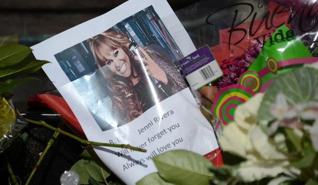 Fans leave flowers and a poster of singer Jenni Rivera at a memorial site on December 10, 2012 in Burbank, California (Photo: Robyn Beck / AFP)