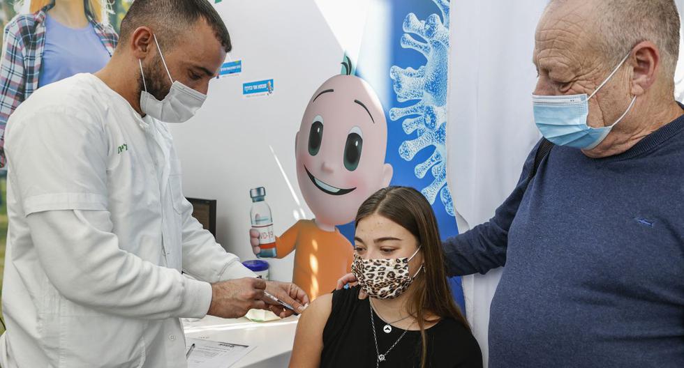 Una adolescente recibe una dosis de la vacuna contra el coronavirus Pfizer-BioNtech en Clalit Health Services, en la ciudad costera mediterránea de Israel de Tel Aviv el 23 de enero de 2021. (JACK GUEZ / AFP).