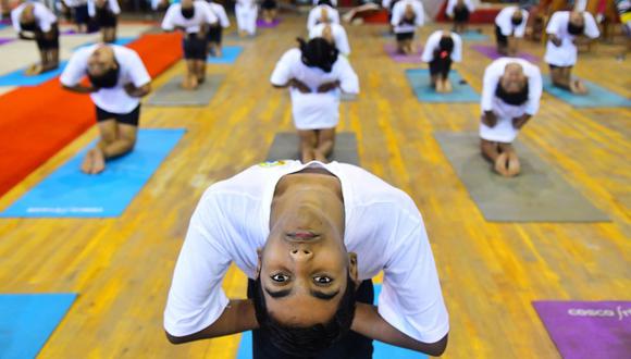 Students perform yoga postures in an indoor stadium on the occasion of International Yoga Day in Agartala, the capital of the Northeastern State of Tripura, on June 21, 2020. (Photo by Abhisek SAHA / AFP)