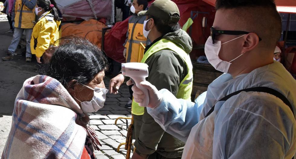 Una trabajadora de salud municipal mide la temperatura de una anciana como precaución contra la propagación del nuevo coronavirus. (AFP/AIZAR RALDES).