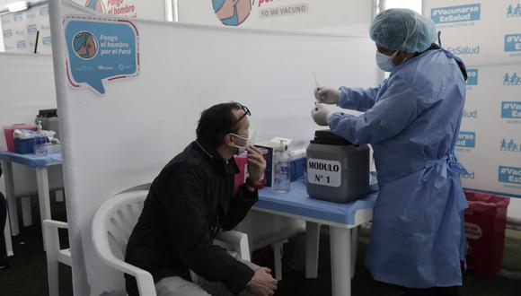 Ciudadano atento a la jeringa que usará el personal de salud para vacunarse en el Complejo Deportivo de San Isidro. (Foto: Jéssica Vicente / GEC)