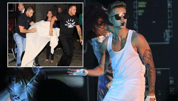 Justin Bieber protegido por su seguridad al salir de prostíbulo. (EFE/Difusión)