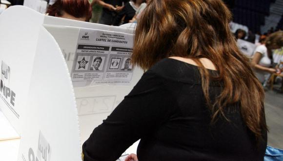 Una peruana escribe en su boleta electoral en un centro de votación en el Palacio de Deportes, en Madrid, en el proceso electoral del 2006. (Foto de JAVIER SORIANO / AFP)