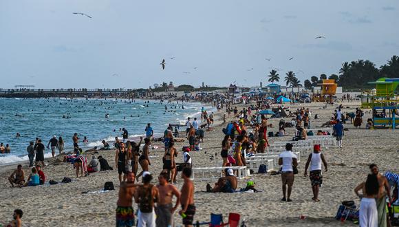 La gente se para en la arena en Miami Beach, Florida, el 6 de septiembre de 2021, durante el feriado del Día del Trabajo. (Foto de CHANDAN KHANNA / AFP)