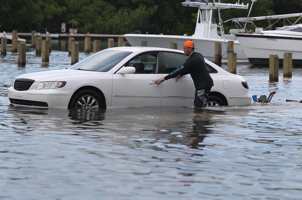 MIAMI BEACH, FLORIDA - AUGUST 30: Weston Rice drives through a flooded parking lot as he prepares to drop his jet ski into the water at the Haulover Marine Center before the arrival of Hurricane Dorian on August 30, 2019 in Miami Beach, United States. The high water was due to King tide which may cause additional problems as Hurricane Dorian arrives in the area as a possible Category 4 storm along the Florida coast.   Joe Raedle/Getty Images/AFP
== FOR NEWSPAPERS, INTERNET, TELCOS & TELEVISION USE ONLY ==
