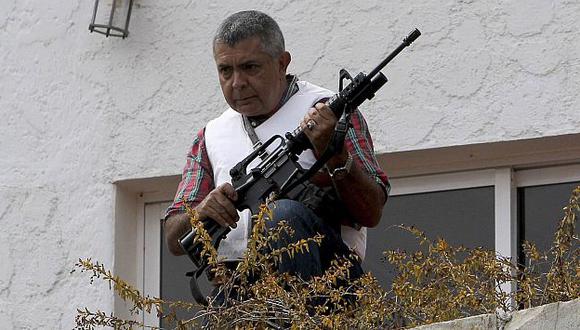 Ángel Vivas espera a las fuerzas del orden con un fusil en la mano. (Reuters)