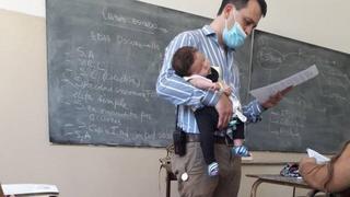 Profesor sostuvo a la bebé de su alumna para que pudiera atender sus clases sin problemas