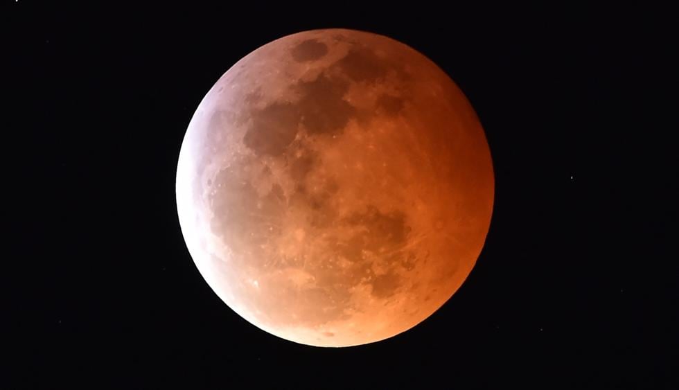 Se ve una Superluna de sangre de lobo durante un eclipse lunar total en Los Angeles, California. (Foto: AFP)