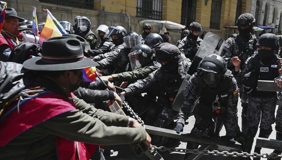 Campesinos indígenas de la provincia de Omasuyos en el altiplano boliviano llamados "Ponchos Rojos" (Ponchos Rojos), se enfrentan con la policía antidisturbios después de marchar desde la ciudad de El Alto hasta la sede del gobierno en La Paz, exigiendo que el gobierno cumpla las promesas para su sector. el 5 de octubre de 2022. (Foto de AIZAR RALDES / AFP)